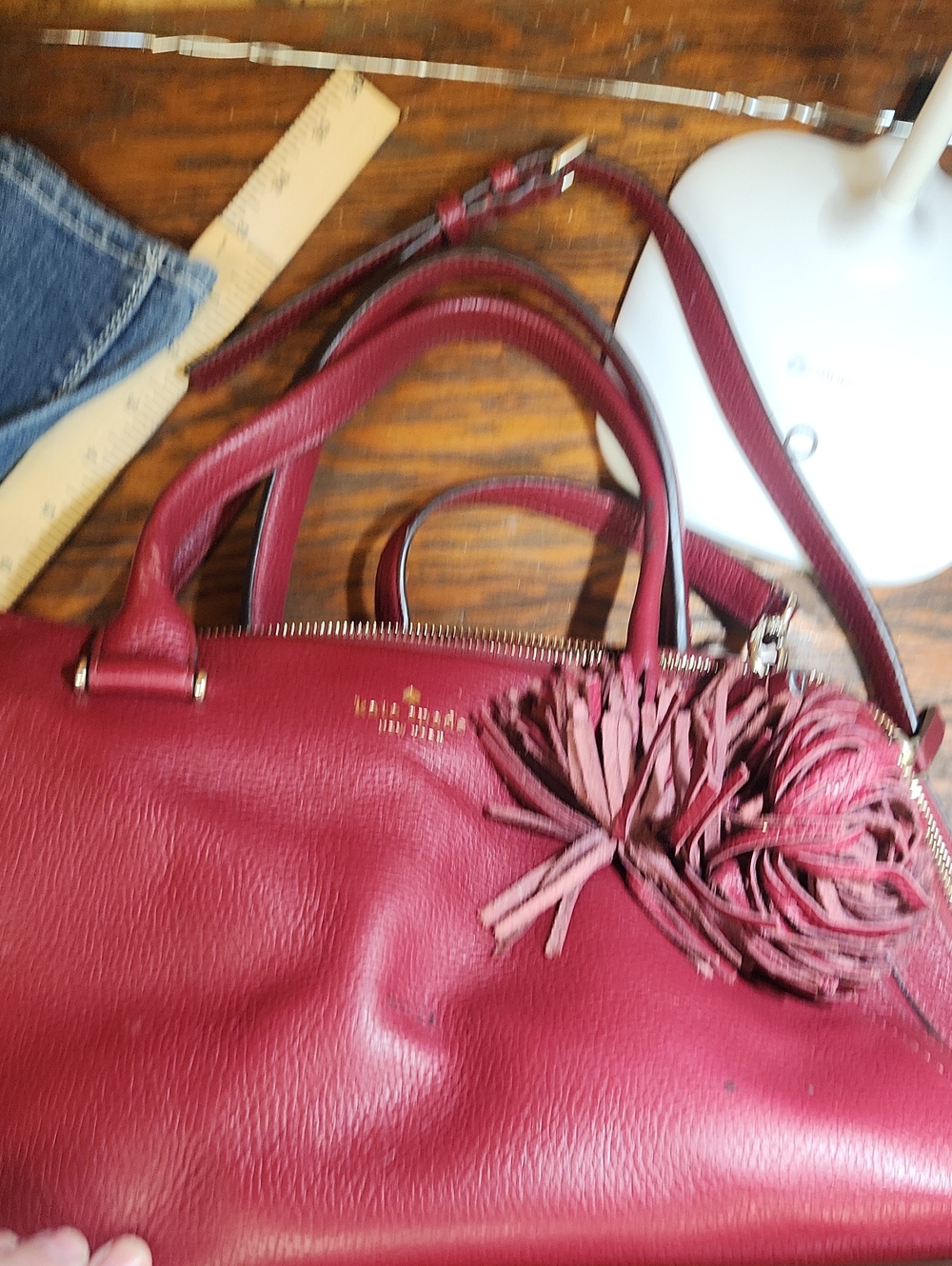 kate spade burgundy leather satchel with tassel charm